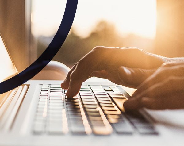 Hands typing on keyboard, browsing an FAQ